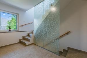 a bathroom with a shower with a glass wall at Domačija Log v Bohinju in Bohinjska Bistrica