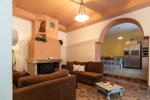 a living room with a couch and a fireplace at Villa Araxovoli in Palaiochora