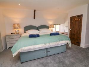 a bedroom with a large bed and two lamps at Whitley Farm in South Molton