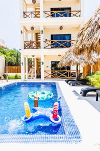 a pool with two inflatables in front of a house at Atenea Holbox in Holbox Island