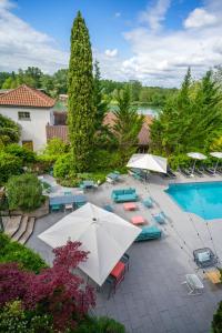 an overhead view of a pool with umbrellas and chairs at Best Western Bridge Hotel Lyon East in Jons