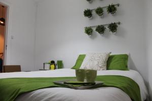 a bedroom with a bed with a tray with plants on it at Window to Lisboa II in Lisbon