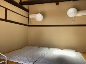a bed in a room with two lights on the wall at Kyoto - Hotel - Vacation STAY 84994v in Kyoto