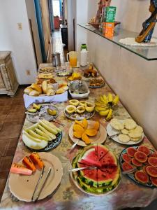 a table with many plates of food on it at Bed & breakfast Villa Carmo in Salvador