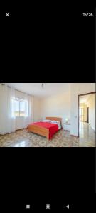 a bedroom with a bed with a red blanket at Casa Melina e enzo in Agnone Bagni