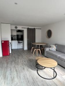 a living room with a couch and a table at Maison neuve Pantin à 5 min de Paris, 2 chambres et 1 canapé-lit in Pantin