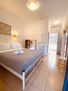 a bedroom with a large bed in a room at Lindos Athena in Lindos