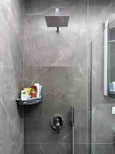 a bathroom with a shower with a sink at Lumi Residence Apartment 2 in Sarandë +13 photos