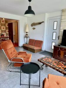 a living room with a couch and a table at Royan Villa 1970 in Royan