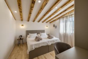 a bedroom with a bed with two pillows on it at Villa Oasis in Kastel Novi