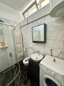 a bathroom with a sink and a washing machine at MaKi apartment in Belgrade +8 photos