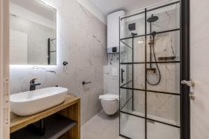 a bathroom with a sink and a glass shower at Villa Oasis in Kastel Novi