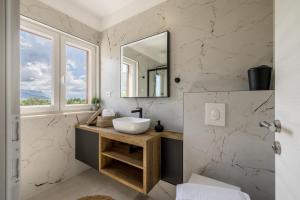 a bathroom with a sink and a mirror at Villa Oasis in Kastel Novi +70 photos