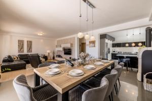 a dining room and living room with a table and chairs at Villa Oasis in Kastel Novi
