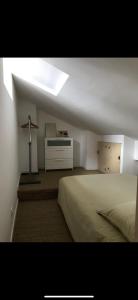 a bedroom with a bed and a cross on the wall at Suite Bergame in Caluire-et-Cuire