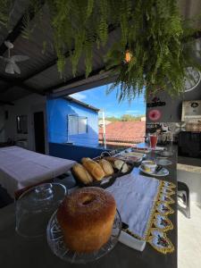 a table with bread and a bagel on it at Flor do Mar - bed and breakfast in Santa Cruz