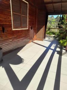 Ein Gehweg führt zu einem Gebäude mit den Schatten der Sonne. in der Unterkunft Chale em Atibaia in Atibaia