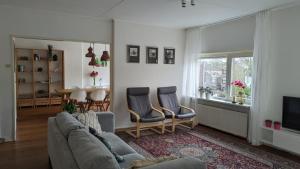 a living room with a couch and chairs and a table at Kust Geluk in Schoorl