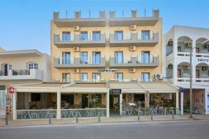 a large building on a city street at Acropolis Apartments in Hersonissos