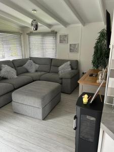 a living room with a couch and a table at Lakeview Lodge, Builth Wells (pet friendly) in Builth Wells