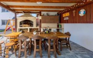 a kitchen with a large wooden table and chairs at Apartman Anavi in Sveti Vid-Miholjice