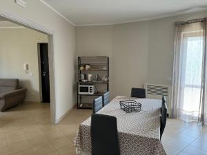 a dining room with a table and a living room at DENIA'S HOME in SantʼEufemia Lamezia