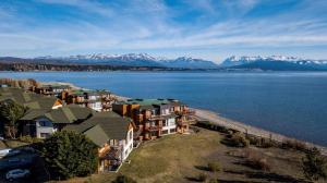an aerial view of houses on the shore of a body of water at Blue Aparts Dina Huapi Bariloche in Dina Huapi