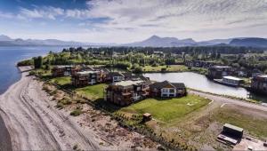 an aerial view of a house on the shore of a lake at Blue Aparts Dina Huapi Bariloche in Dina Huapi