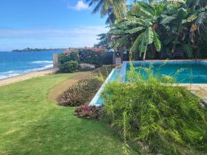 a swimming pool next to a beach with the ocean at On the Beach in Black Rock