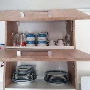 a shelf with blue and white dishes in a kitchen at Dézsa-vü Vendégház in Sarud