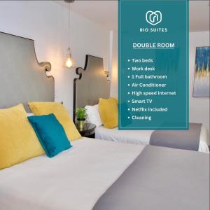 a bedroom with two beds with yellow and blue pillows at Rio Suites in Tijuana