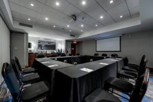 a conference room with a long table and chairs at Holiday Inn Express Hotel & Suites Saint - Hyacinthe by IHG in Saint-Hyacinthe +17 photos