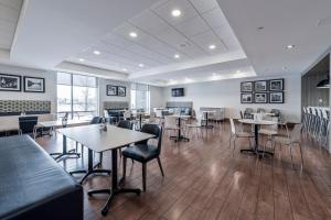 a restaurant with tables and chairs in a room at Holiday Inn Express Hotel & Suites Saint - Hyacinthe, an IHG Hotel in Saint-Hyacinthe
