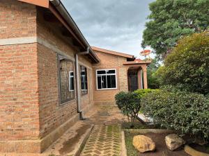 a brick house with a window on the side of it at Njombe Cozy House in Njombe