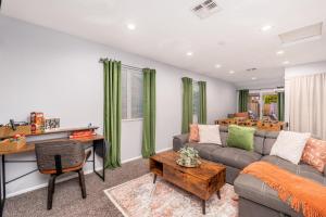 a living room with a couch and a table at Sunshine Oasis! Heated Pool, Mini Golf, Sleeps 12 in Scottsdale +49 photos