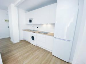 a white kitchen with a sink and a dishwasher at Tarifa Ocean Side Tu espacio de descanso in Tarifa +12 photos