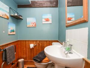 a bathroom with a sink and a toilet at Gardeners Cottage in Millom +26 photos
