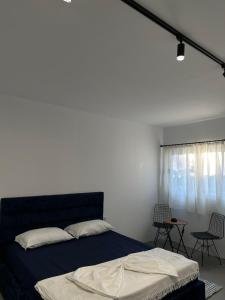 a bedroom with a bed and a table and chairs at Sunny Rentals in Vlorë