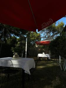 a table and chairs under an umbrella in a yard at Sunny Rentals in Vlorë