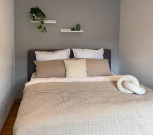 a bed in a bedroom with a white wall at NORA One in Traben-Trarbach