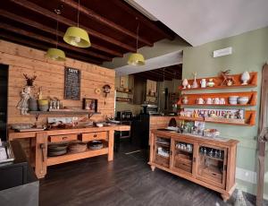 a kitchen with wooden walls and a counter with pots and pans at Heidi Bed and Breakfast in Albavilla