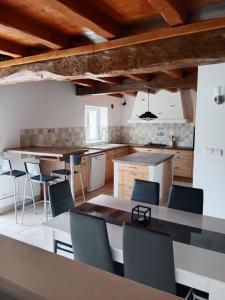a large kitchen with a table and chairs at La grange pyratelle in Puyravault +11 photos