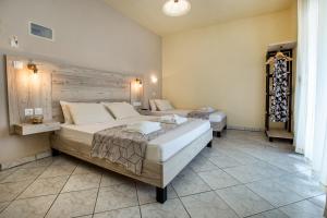 a bedroom with a large bed in a room at Ianos Apartments in Potos