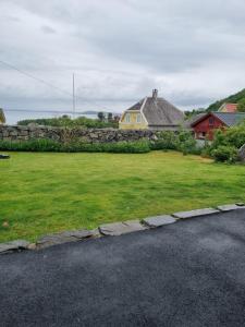 een tuin met een stenen muur en een huis bij Not far from famous Pulpit Rock and Stavanger in Strand