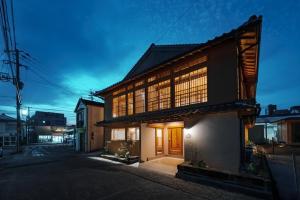 a large building with windows on the side of a street at Ikeda Ryokan - Vacation STAY 79298v in Nishinoomote