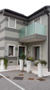 a building with white pots of plants in front of it at Sweet Home in Treviso