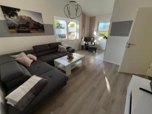 a living room with a couch and a table at Ferienhaus Glücksmoment in Blankenburg