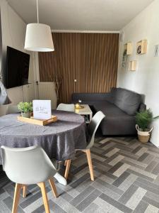 a living room with a table and a couch at Ostsee Ferienhaus Usedom hundefreundlich Familie Stopp Haus 22 in Lütow