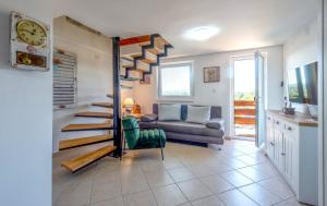 a living room with a spiral staircase and a couch at Lily's Rural House in Jarki Horvatićevi