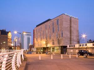 
a large building with a clock on the side of it at Sleeperz Hotel Cardiff in Cardiff
